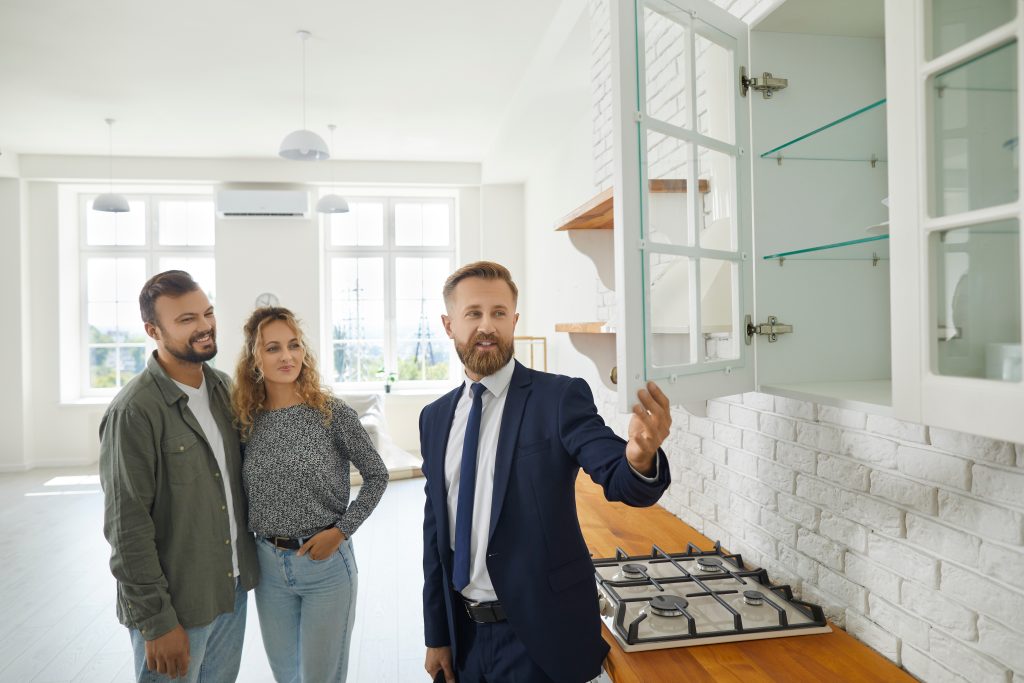 estate agent and couple in new home
