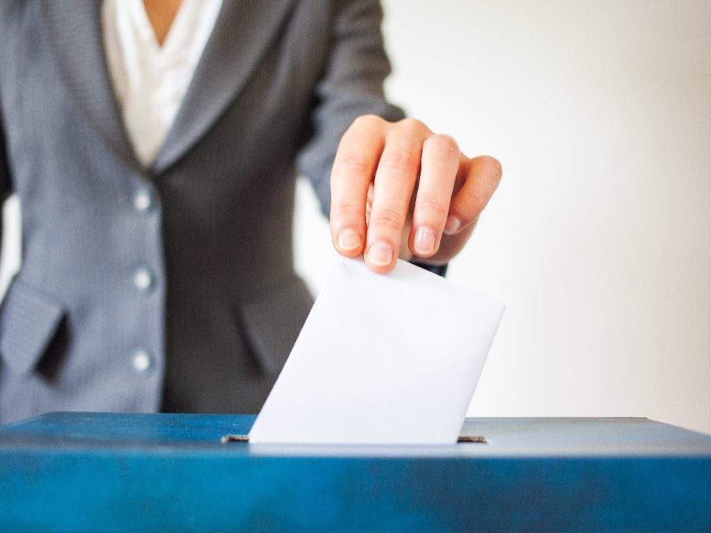 woman voting at ballot box